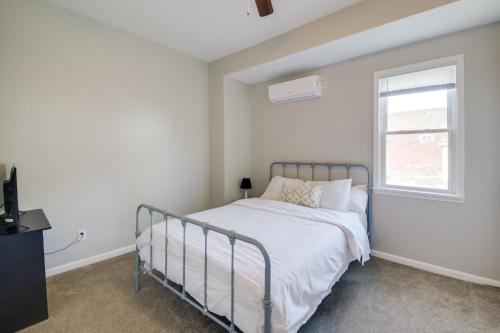 a white bedroom with a bed and a window at Indianapolis Home with Porch - Close to Mile Square! in Indianapolis