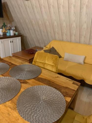 a living room with tables and a couch at Siedlisko Kępina Zdrój in Ostrów