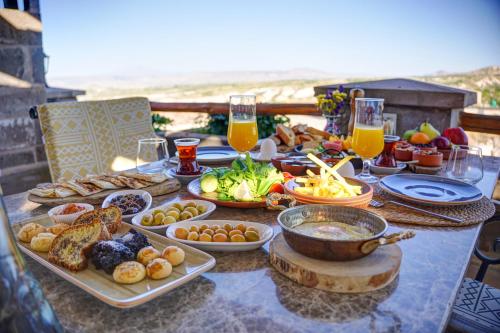 a table with a buffet of food and drinks at Petra Inn Cappadocia Luxury in Uchisar