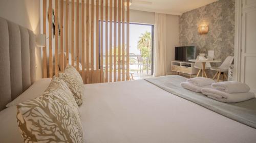 a bedroom with a bed with towels on it at Maresía Village in Los Realejos
