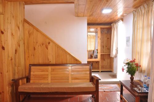 een woonkamer met een bank en een trap bij Lilly's Valley Resort in Kodaikānāl
