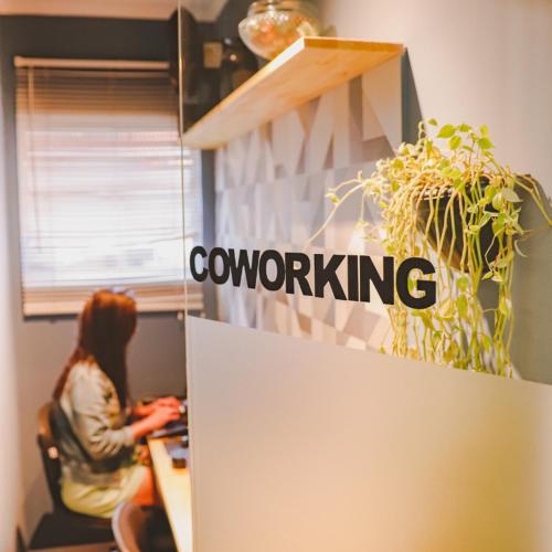 a woman sitting at a desk in an office at Hostel new way in Sao Paulo