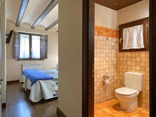 a bathroom with a bed and a toilet in a room at Casa Rural juaningratxi in Isaba
