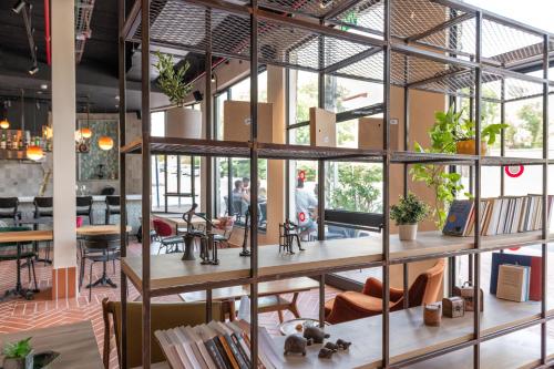 a large glass wall in a room with tables and chairs at HOTEL SHOSHANA in Eilat