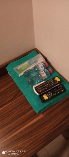 un tavolo con due telecomandi su un asciugamano verde di Bromo Family Guest House a Kepanjen