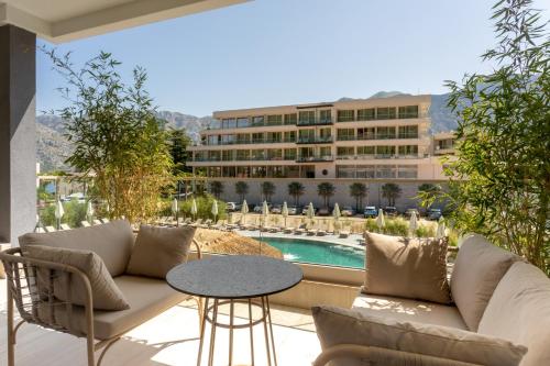 a patio with a couch and a table and a building at Hyatt Regency Kotor Bay Resort in Kotor