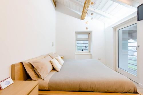 a bedroom with a large bed and a window at B&B Il Piccolo Principe room and breakfast in Bieno