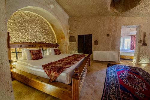 a bedroom with a large bed in a large room at Roma Cave Suite in Goreme