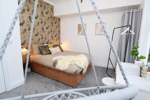 a bedroom with a swing bed in a room at Bliss on the Bay in Eastbourne
