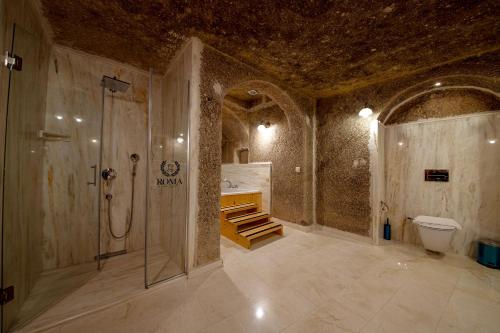 a bathroom with a shower and a toilet and a sink at Roma Cave Suite in Goreme