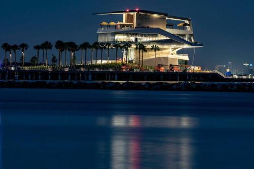 a cruise ship lit up at night next to the water at Heated Pool House: Beach 3Miles · Bar · BBQ & GYM! in Largo