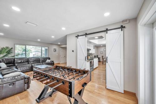 a living room with a couch and a large open door at Heated Pool House: Beach 3Miles · Bar · BBQ & GYM! in Largo