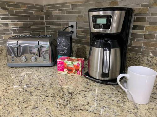 a coffee maker and a toaster on a counter at Heated Pool House: Beach 3Miles · Bar · BBQ & GYM! in Largo