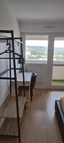 a room with a desk and a table and two windows at Chambre privé avec loggia chez l'habitant in Champigneulles