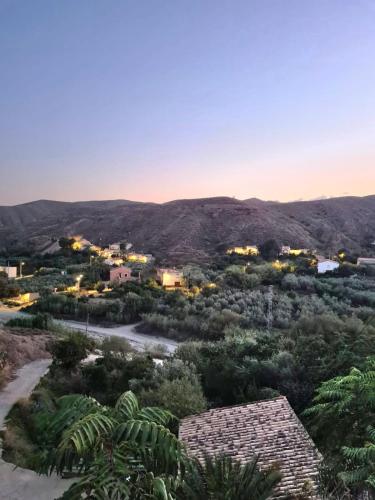 a view of a village with mountains in the background at Casa Tropical, serene poolside retreat in nature in Albox