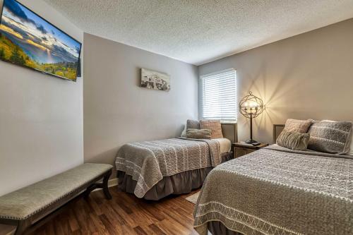 a bedroom with two beds and a window at Cozy Resort-Style Condo Less Than 2 Mi to Ober Gatlinburg! in Gatlinburg