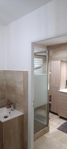 a kitchen with a glass door leading into a kitchen at Chambre privé avec loggia chez l'habitant in Champigneulles