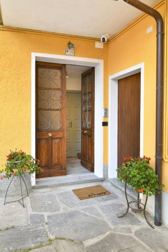 a front door of a house with two plants at La Terrazza in Malesco
