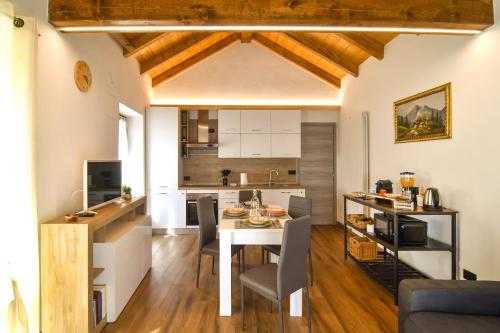 a kitchen and living room with a table and chairs at La Terrazza in Malesco