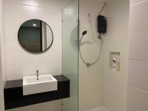 a bathroom with a sink and a shower with a mirror at Trefoil Studio Comfy 3-Shah Alam in Shah Alam