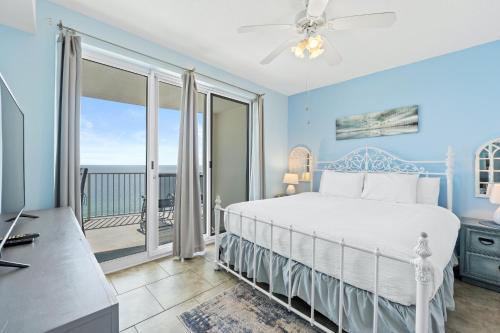 a bedroom with a bed and a balcony at Twin Palms Beach Resort by Panhandle Getaways in Panama City Beach