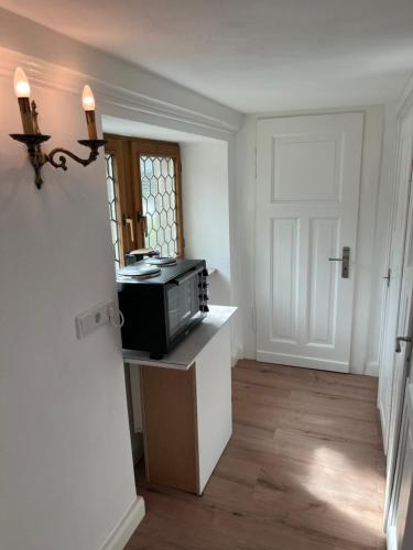 a room with a microwave on a counter with a door at Moseltürmchen Cochem in Cochem