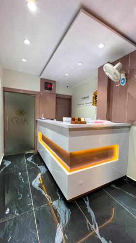 a kitchen with a counter in a room at Hotel Czar Inn in Surat