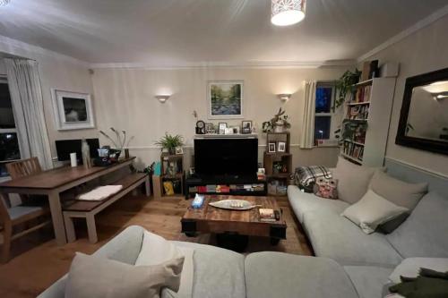 a living room with a couch and a table at Calming 1BD Oasis by River Thames - Rotherhithe in London