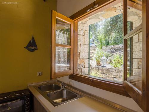 a kitchen with a sink and a window at Adamantia Studio S3 in Gaios
