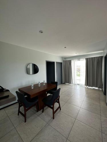 a dining room with a wooden table and chairs at Casa Picacho by Cobo´s in Aguascalientes
