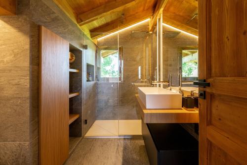 La salle de bains est pourvue d'un lavabo et d'un miroir. dans l'établissement Megève - Chalet Miage, à Demi-Quartier