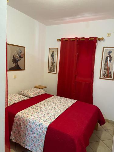 a bedroom with a bed and a red curtain at Apto Martins - Residencial Inês N 23 in Vila do Porto