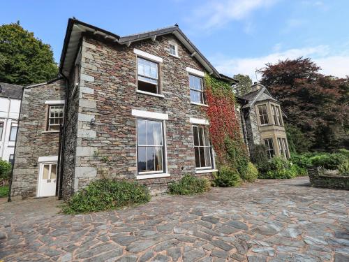a brick house with a stone driveway at Easedale in Grasmere