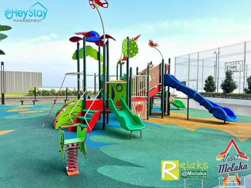 a playground with a slide and a slidesktop at Amber Cove Impression City By Heystay Management in Melaka