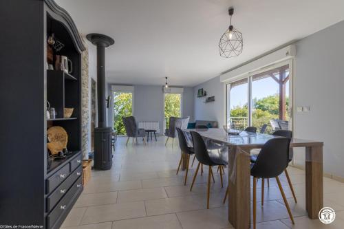 a kitchen and dining room with a table and chairs at Tri-O-Bois in Thianges