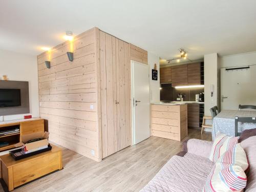 a living room with a large wooden wall at Studio Neuf Confort, Balcon, Centre Station, 4 Pers, Flaine Forêt - FR-1-425-170 in Flaine