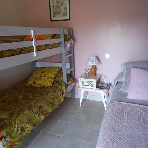 a bedroom with two bunk beds and a side table at Boufavent in Salettes