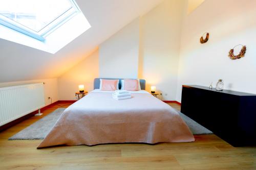a bedroom with a bed and a skylight at Luxury Suites Stay in Antwerp
