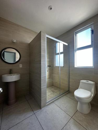 a bathroom with a toilet and a shower and a sink at Casa Picacho by Cobo´s in Aguascalientes