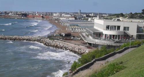 a view of a beach with a building and the ocean at Playa grande in Mar del Plata
