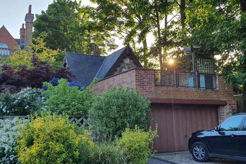 a house with a garage and a car parked in front at Unique 3 b'room house + free parking /city centre in Nottingham