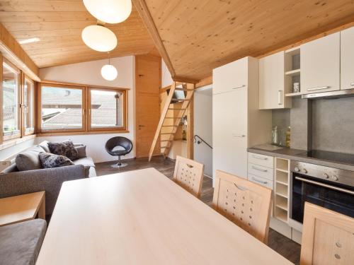a kitchen and living room with a table in a tiny house at Falwesuna Apartments in Neustift im Stubaital