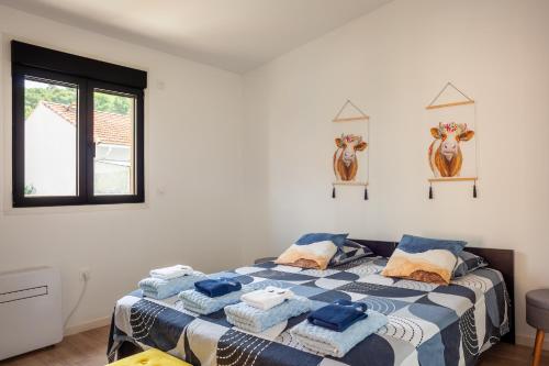 a bedroom with a bed with blue and white sheets at Villa Tania in Allauch