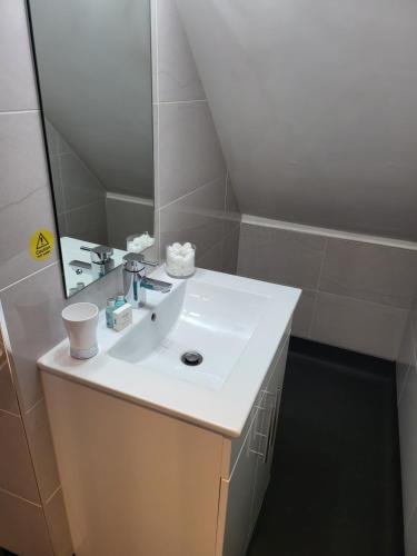 a bathroom with a white sink and a mirror at Harrogate Lifestyle Luxury Serviced ApartHotel in Harrogate