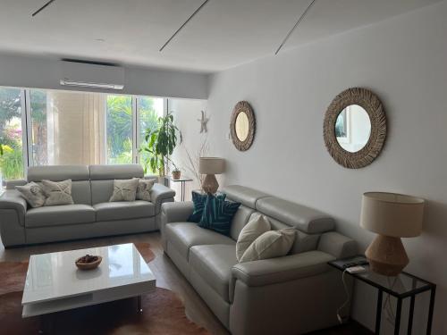a living room with a couch and a table at Modern Seaview Townhouse in Coral Bay in Peyia