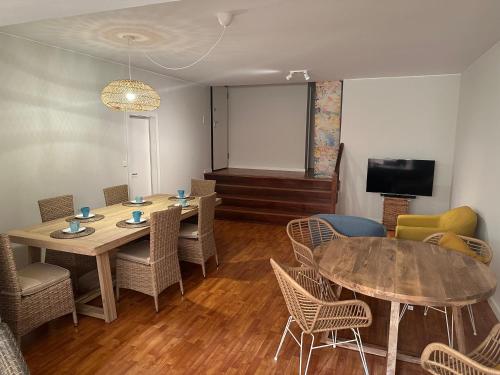 a meeting room with two tables and chairs and a screen at Porto Foz Beach in Porto