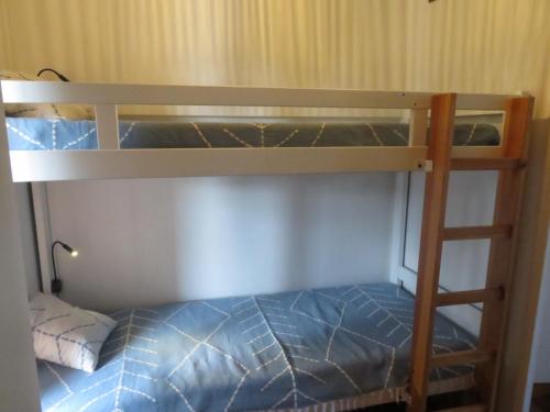a bedroom with two bunk beds with blue sheets at Studio week-end mer in Saint-Cyr-sur-Mer