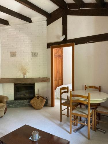 a living room with a table and a fireplace at Apartamento Picos de Europa in Cabezón de Liébana