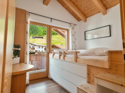 a bedroom with a bed and a window at Falwesuna Apartments in Neustift im Stubaital
