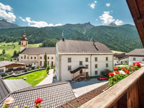 a view of a village with a church and mountains at Falwesuna Apartments in Neustift im Stubaital